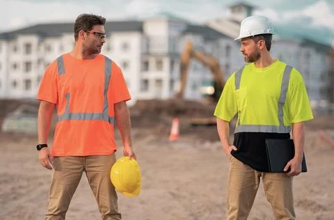 Two engineers. Architect at a construction site. Handyman builders in hardhat Stock Photos