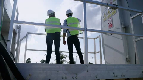 Two engineers are standing together discussing wind power projects and work Stock Footage 165444836