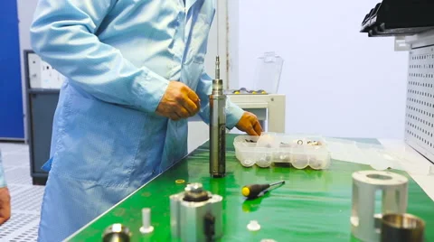 Two Engineers Are Testing the Device on a Green Table Uniform Tech Lab Stock Footage 60579723