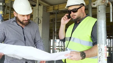 Two engineers browsing building project. Slider shot left. 動画素材 70787235