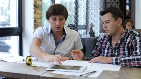 Two engineers of the builder check the drawings Stock Footage 87128659