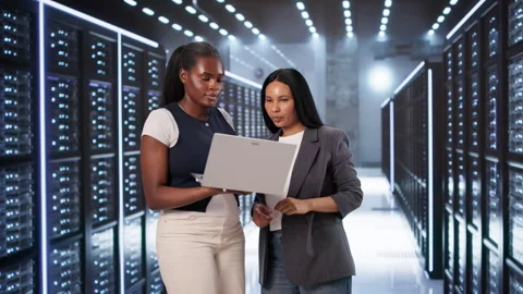 Two Engineers Collaborate On Laptops Managing Secure Cloud Systems Stockbeeldmateriaal 333846040