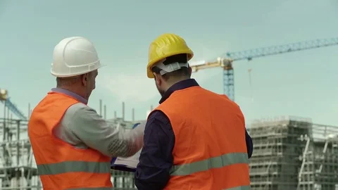 Two engineers at the construction site control work in progress Stock Footage 71891907