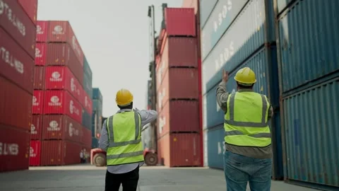 Two engineers control loading container on delivery at container yard. Logistics Stock Footage 264759818