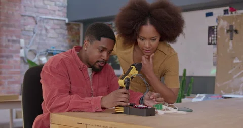 Two Engineers Developing Robot Technology in Workshop Stock Footage 241828594