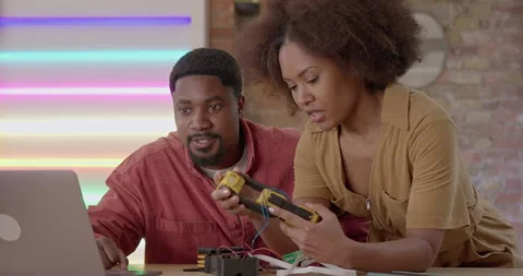 Two Engineers Developing Robot Technology in Workshop Stock Footage 241830008