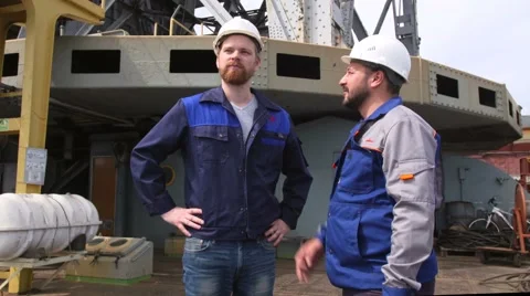 Two engineers discuss project in cargo port Stock Footage 65403650