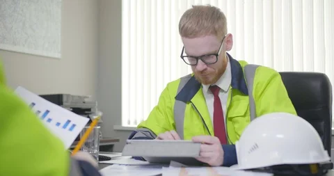 Two engineers discuss project in office. Stock Footage 107384236