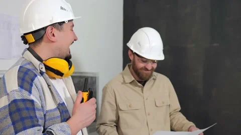 Two engineers discuss the project standing at a construction site Stock Footage 234829487