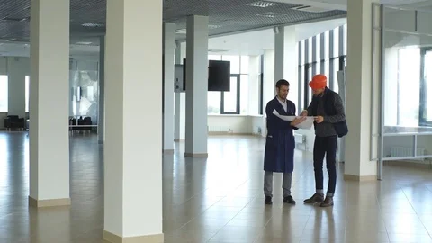 Two engineers discussing the construction plan Stock Footage 70796264