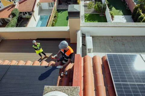 Two Engineers doing maintenance inspection of solar panels Stock Photos