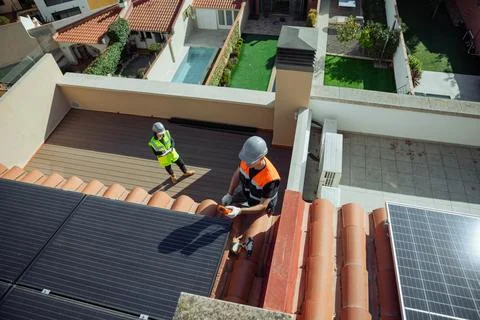 Two Engineers doing maintenance inspection of photovoltaic panels Stock Photos