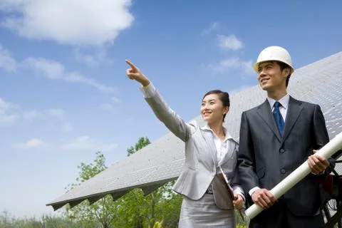 Two engineers in front of solar panels Stock Photos