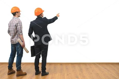 The two engineers gesture on the white wall background Stock Photos