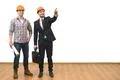 The two engineers gesture on the white wall background Photo