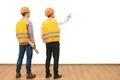 The two engineers gesture on the white wall background Photo