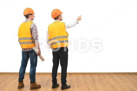 The two engineers gesture on the white wall background Stock Photos