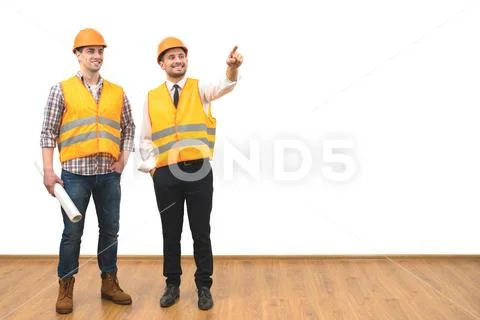 The two engineers gesture on the white wall background Stock Photos