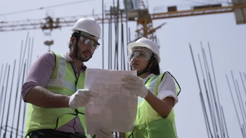 Two Engineers holding drawing work on construction site. Vídeos de archivo 162016698
