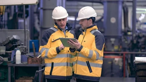 Two engineers at an industrial plant. Two workers control the work at the Stock Footage 171775474