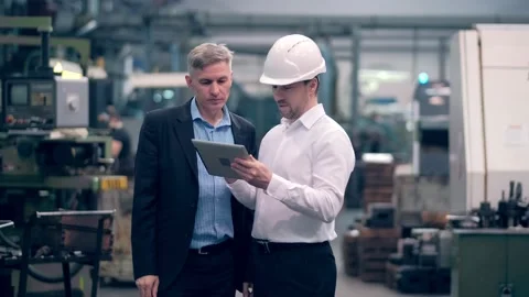 Two engineers at an industrial plant. Two workers control the work at the Stock Footage 172015524