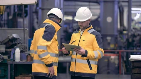 Two engineers at an industrial plant. Two workers control the work at the Stock Footage 172016021