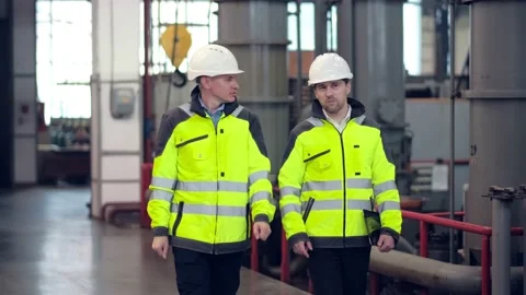 Two engineers at an industrial plant. Two workers control the work at the Stock Footage 172016694