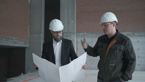 Two Engineers Meet At Construction And Consult Building Project. Two Engineers Stock Footage 106870282