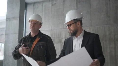 Two Engineers Meet At Construction And Consult Building Project. Two Engineers Stock Footage 106870656
