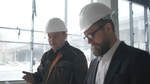 Two Engineers Meet At Construction And Consult Building Project. Two Engineers Stock Footage 106871119