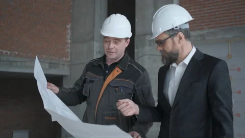 Two Engineers Meet At Construction And Consult Building Project. Two Engineers Stock Footage 106871393