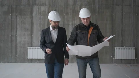 Two Engineers Meet At Construction And Consult Building Project. Two Engineers Stock Footage 106871837