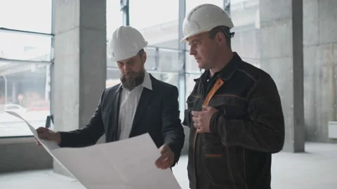 Two Engineers Meet At Construction And Consult Building Project. Two Engineers Видео 106872392