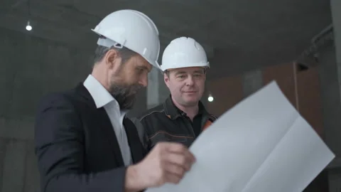 Two Engineers Meet At Construction And Consult Building Project. Two Engineers Stock Footage 106872799