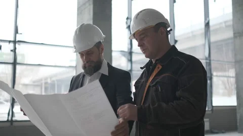 Two Engineers Meet At Construction And Consult Building Project. Two Engineers Stock Footage 106873300