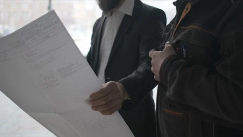 Two Engineers Meet At Construction And Consult Building Project. Two Engineers Stock Footage 106873911