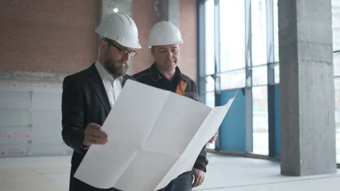 Two Engineers Meet At Construction And Consult Building Project. Two Engineers Stock Footage 106880888