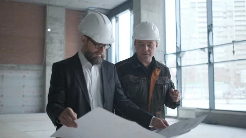 Two Engineers Meet At Construction And Consult Building Project. Two Engineers Stock Footage 106881175