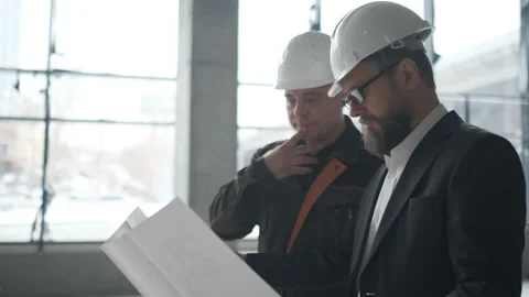 Two Engineers Meet At Construction And Consult Building Project. Two Engineers Stock Footage 106881830