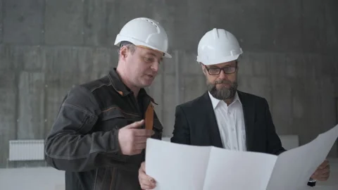 Two Engineers Meet At Construction And Consult Building Project. Two Engineers Stock Footage 106882076