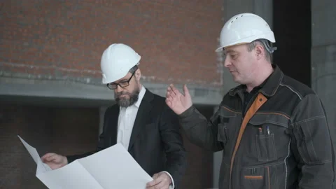Two Engineers Meet At Construction And Consult Building Project. Two Engineers Stock Footage 106883110