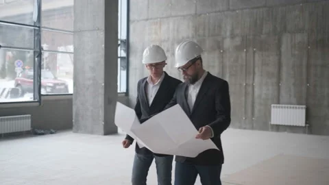 Two Engineers Meet At Construction And Consult Building Project. Two Engineers Stock Footage 106991039