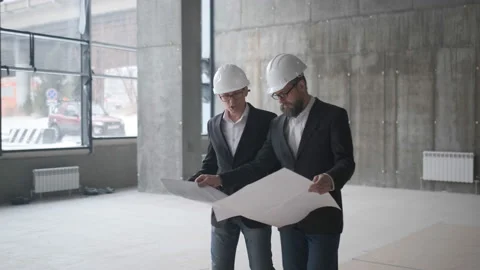 Two Engineers Meet At Construction And Consult Building Project. Two Engineers Stock Footage 107076831