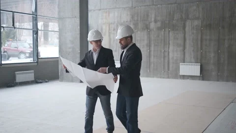 Two Engineers Meet At Construction And Consult Building Project. Two Engineers Stock Footage 107076927