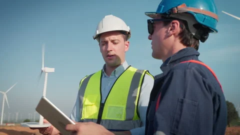 Two engineers men working at wind turbine farm. Vídeos de archivo 228997821