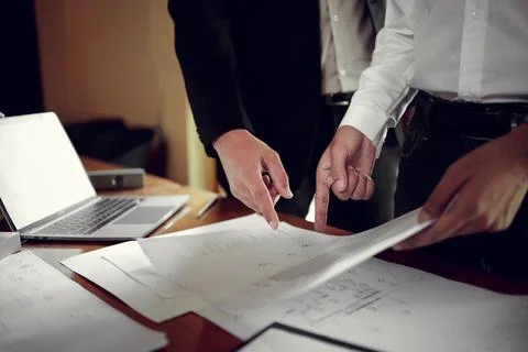 Two engineers pointing at drawings project, Architect team meeting consult .. Stock Photos