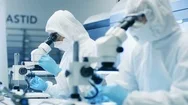 Two Engineers/ Scientists/ Technicians In Sterile Cleanroom Suits Use Microscope Stock Footage