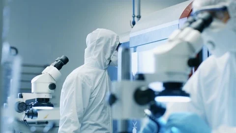 Two Engineers/ Scientists/ Technicians in Sterile Cleanroom Suits. Stock Footage 82255710