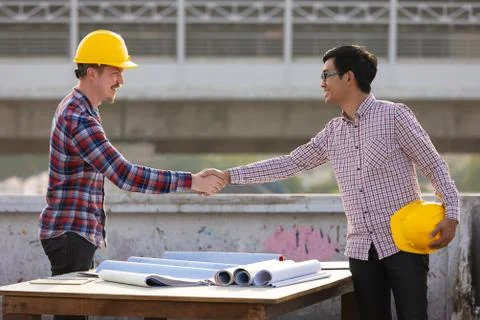 Two engineers shaking hands Stock Photos