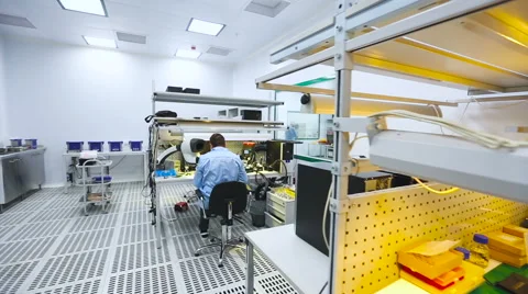 Two Engineers Sitting at Their Workstations and Learn the Details of a Video stock 60583194